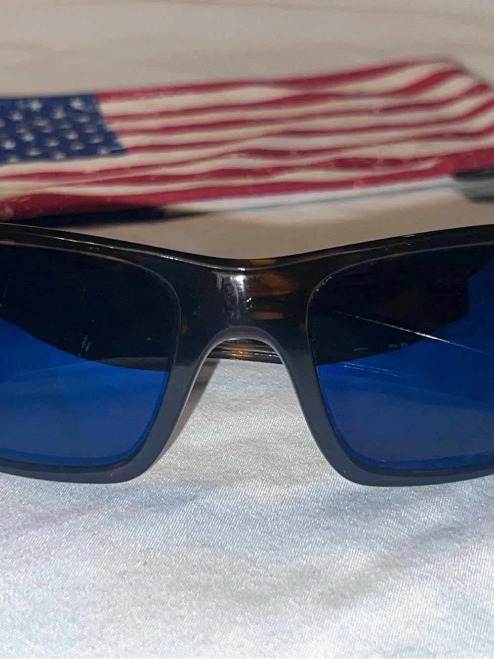 Oakley Tortoise Frame Sunglasses with Blue Lenses and American Flag Accent
